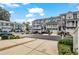 Neighborhood street showcasing townhomes with garages, tidy landscaping, and street parking at 3014 Liberty Nw Way, Atlanta, GA 30318