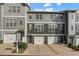 Attractive townhome exterior with a two-car garage, covered entry, and professionally landscaped front yard at 3014 Liberty Nw Way, Atlanta, GA 30318