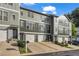 Well-maintained townhome exterior with a private garage, manicured lawn, and convenient driveway at 3014 Liberty Nw Way, Atlanta, GA 30318