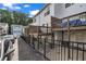 Townhome features upper and lower decks, black metal fence, and ample parking at 3014 Liberty Nw Way, Atlanta, GA 30318