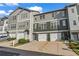 Charming townhome exterior featuring a private garage, well-maintained landscaping, and inviting curb appeal at 3014 Liberty Nw Way, Atlanta, GA 30318