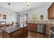 Bright kitchen with stainless appliances, wood cabinets, granite counters, and eat-in dining area at 3014 Liberty Nw Way, Atlanta, GA 30318