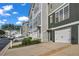 Street-level view of townhomes with attached garages and well-kept landscaping along the street at 3014 Liberty Nw Way, Atlanta, GA 30318
