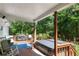Covered back deck featuring a hot tub, lounge furniture, and outdoor grill area at 435 Old Holly Rd, Milton, GA 30075