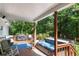 Covered back deck featuring a hot tub with lounge and entertaining area and grilling area at 435 Old Holly Rd, Milton, GA 30075
