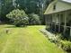Expansive backyard with lush lawn, screened-in porch, and verdant landscaping at 435 Old Holly Rd, Milton, GA 30075