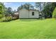 Expansive grassy backyard featuring the rear exterior of the home and deck at 435 Old Holly Rd, Milton, GA 30075