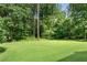 A well-maintained lawn offers a versatile area for outdoor activities in this lush backyard at 435 Old Holly Rd, Milton, GA 30075