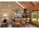 Charming bar area featuring wood paneled walls, custom shelving, and seating for three at 435 Old Holly Rd, Milton, GA 30075