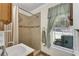 Cozy bathroom featuring tiled shower, neutral walls and decorative curtains at 435 Old Holly Rd, Milton, GA 30075