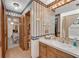 En-suite bathroom featuring a vanity area, wood cabinets, and view into the jacuzzi tub at 435 Old Holly Rd, Milton, GA 30075