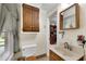 Bathroom featuring wooden fixtures, neutral walls, and a window at 435 Old Holly Rd, Milton, GA 30075