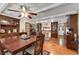 Cozy dining room featuring hardwood floors, a ceiling fan, and wood cabinets for displaying dishware at 435 Old Holly Rd, Milton, GA 30075