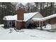 Exterior winter view of home with brick chimney and covered entryway in the snow at 435 Old Holly Rd, Milton, GA 30075