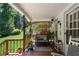 Charming covered front porch with comfortable seating, plants, and decorative accents at 435 Old Holly Rd, Milton, GA 30075