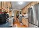 Modern kitchen with stainless steel appliances, wood cabinets, and granite countertops at 435 Old Holly Rd, Milton, GA 30075
