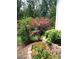 Beautifully landscaped yard featuring colorful flowers, shrubs, and a stone retaining wall at 435 Old Holly Rd, Milton, GA 30075