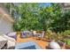 Outdoor dining with grill and conversation area on the back deck with wooded views at 435 Old Holly Rd, Milton, GA 30075