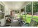 Inviting screened-in porch with comfortable seating, greenery views, and brick walls at 435 Old Holly Rd, Milton, GA 30075