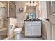 Bathroom featuring a toilet, shower with glass, granite countertop, and vanity with sink at 711 Topsail Ln, Alpharetta, GA 30005