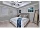 Comfortable bedroom featuring neutral walls, plush carpeting, ceiling fan, and large windows offering natural light at 711 Topsail Ln, Alpharetta, GA 30005
