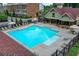 Community pool with lounge chairs, seating under a pergola, and a surrounding fence at 711 Topsail Ln, Alpharetta, GA 30005