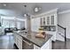 Open kitchen featuring granite countertops and a large island at 711 Topsail Ln, Alpharetta, GA 30005