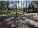 Large backyard with a small red storage shed or outbuilding, surrounded by mature trees at 1288 Skyview Sw Cir, Mableton, GA 30126