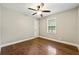Bedroom with hardwood floors, ceiling fan, and neutral paint at 4110 Oak Ferry Ne Dr, Kennesaw, GA 30144
