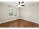 Bedroom with wood floors, ceiling fan, and natural light at 4110 Oak Ferry Ne Dr, Kennesaw, GA 30144