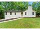 Charming single-story home with a brick chimney and a well-manicured lawn at 4110 Oak Ferry Ne Dr, Kennesaw, GA 30144