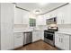 Modern kitchen with stainless steel appliances, white cabinets, and a tile backsplash at 4110 Oak Ferry Ne Dr, Kennesaw, GA 30144