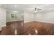 Spacious living room with hardwood floors, crown molding, and a ceiling fan at 4110 Oak Ferry Ne Dr, Kennesaw, GA 30144