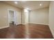 Finished basement area featuring hardwood floors and multiple doors to a bathroom, closet and storage at 5836 Sandy Springs Cir, Atlanta, GA 30328