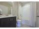 Bathroom featuring tile flooring, vanity with modern fixtures, and a shower-tub combination with white tile surround at 5836 Sandy Springs Cir, Atlanta, GA 30328