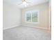 Neutral bedroom with carpet flooring, a ceiling fan and a window with blinds at 5836 Sandy Springs Cir, Atlanta, GA 30328