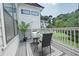 Outdoor deck overlooking a green lawn with a table and chair set for relaxing at 5836 Sandy Springs Cir, Atlanta, GA 30328