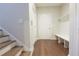 Inviting entryway with hardwood floors, a storage bench and stairs leading to the upper level at 5836 Sandy Springs Cir, Atlanta, GA 30328