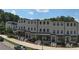 Attractive townhome exteriors with brick accents, black window frames and covered entryways at 5836 Sandy Springs Cir, Atlanta, GA 30328
