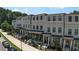 Attractive townhome exteriors with brick accents, black window frames and covered entryways at 5836 Sandy Springs Cir, Atlanta, GA 30328