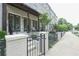 Charming townhouse exterior featuring painted brick, covered front porch, and stylish iron fence at 5836 Sandy Springs Cir, Atlanta, GA 30328