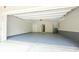 Spacious two-car garage with painted floor and access door to the home at 5836 Sandy Springs Cir, Atlanta, GA 30328