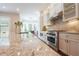 Gourmet kitchen featuring granite countertops, stainless steel appliances, and custom cabinetry at 5836 Sandy Springs Cir, Atlanta, GA 30328