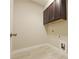 Functional laundry area with upper cabinets and tile flooring at 5836 Sandy Springs Cir, Atlanta, GA 30328