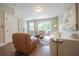 Bright living room showcasing hardwood floors and access to outdoor balcony at 5836 Sandy Springs Cir, Atlanta, GA 30328