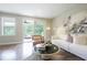 Stylish living room showcasing hardwood floors and access to outdoor balcony at 5836 Sandy Springs Cir, Atlanta, GA 30328
