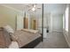 Main bedroom with neutral tones, a four-poster bed, and a view of the walk-in closet at 5836 Sandy Springs Cir, Atlanta, GA 30328