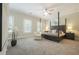 Spacious main bedroom featuring a four-poster bed, sitting area, and large windows at 5836 Sandy Springs Cir, Atlanta, GA 30328