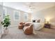 Cozy main bedroom with neutral colors, two leather chairs and natural light, perfect for relaxation at 5836 Sandy Springs Cir, Atlanta, GA 30328