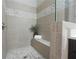 Neutral tiled shower with built-in seat and decorative tile accent at 5836 Sandy Springs Cir, Atlanta, GA 30328